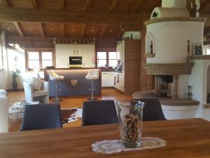 a glass sitting on a table in a living room at LuxusChalet Happy Home Tyrol in Ellmau
