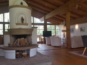 a living room with a fireplace in a house at LuxusChalet Happy Home Tyrol in Ellmau
