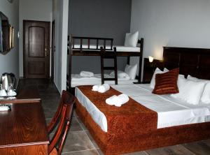 a bedroom with two bunk beds and a table at Paralia Beach Boutique Hotel in Paralia Katerinis