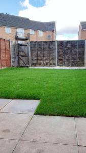 a yard with a fence and green grass at Seymour Road - Parking for van - Contractors only in Oldbury