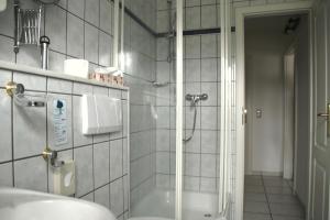 a bathroom with a shower and a sink at Bei Ulbrichs Hotel garni & Catering in Soltau