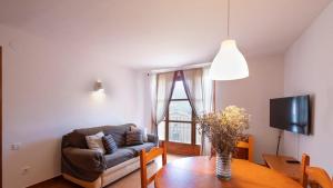 a living room with a couch and a table at La Era de Navarri - Bonansa in Bonansa