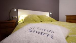 a bed with a blanket that says i might bemite at La Era de Navarri - Bonansa in Bonansa