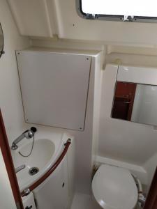 a small bathroom with a sink and a toilet at Boat in Badalona for up to 6 people in Badalona