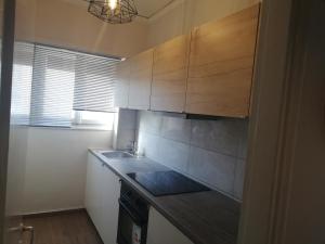 a kitchen with a sink and a counter top at Central in Patra