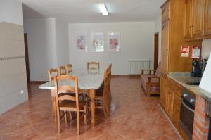 a kitchen with a table and chairs in a kitchen at Hope House in Esperança
