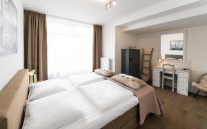Postel nebo postele na pokoji v ubytování Het Vlielandhotel