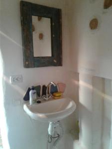 ein weißes Waschbecken im Bad mit Spiegel in der Unterkunft Сказочный Дом (Fairy House) in Buki