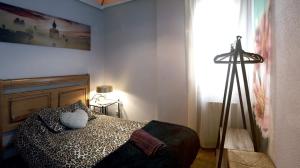 a bedroom with a bed with a pillow on it at IKIGAI wifi , Neflitx in Logroño