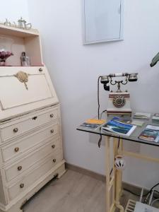 a room with a dresser and a desk with a machine at CARBALLO DE PRADO 1900 in Pontevedra