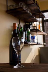 una bottiglia di vino seduta accanto a un bicchiere di vino di Lilac Elevate Inn a Karatu