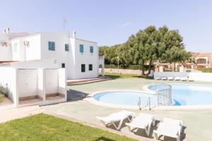 a villa with a swimming pool and a house at Apartamento SARAY in Son Carrio