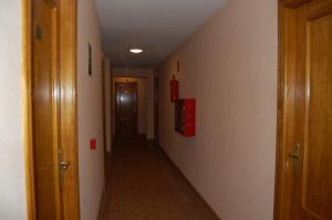 a room with a red wall and a red door at Hotel Los Duques in Béjar