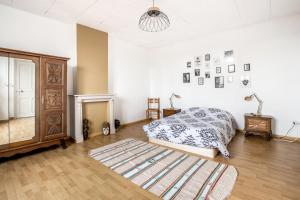 a bedroom with a bed and a dresser at Chez Charlotte in Angres