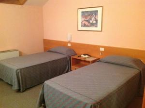 a hotel room with two beds and a picture on the wall at Hotel Villa Reale in Argenta +33 photos
