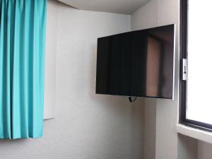 a flat screen tv hanging on a wall at Hotel Corona Plaza in Rosarito