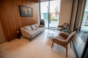 a living room with a couch and two chairs at Belgrade Waterfront GREEN Apartment in Belgrade