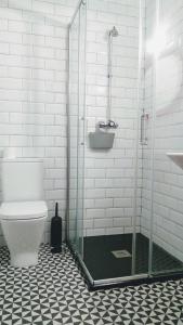 a bathroom with a toilet and a glass shower at A Conserveira in Redondela