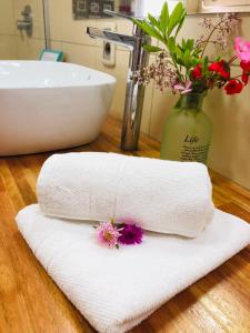 a white towel sitting on a bathroom counter with a sink at Unique Hotel & Suites in Punta Del Diablo