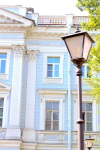 a street light in front of a blue building at Ligovsky yard in Saint Petersburg