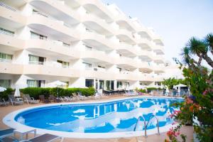 a swimming pool in front of a hotel at Adults Only Sunny Quiet Apartment in Center of Las Americas in Arona