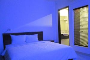 Postel nebo postele na pokoji v ubytování Apogee Hotel