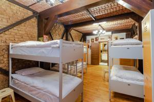 a room with three bunk beds in a brick wall at Sanat Hostel Taksim in Istanbul +125 photos
