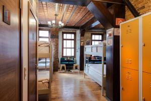 a dorm room with bunk beds and a hallway at Sanat Hostel Taksim in Istanbul