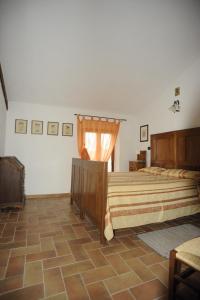 a bedroom with two beds and a window at La Miniera in Montefollonico