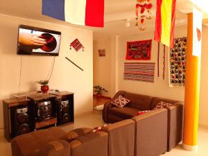 a living room with a couch and a tv at Marlon's House Nasca in Nazca