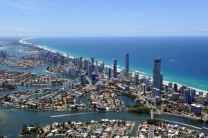 a large body of water with a city skyline at Norfolk Luxury Beachfront Apartments in Gold Coast
