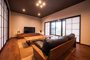 a living room with a couch and a wooden table at Kimachi-tei（きまち亭） in Toyama