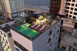 an aerial view of a building with a swimming pool at Sofiana My Khe Hotel & Spa- Rooftop Pool Bar in Danang