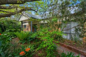 a house with a garden in front of it at Bungunyah Apartments in Croydon