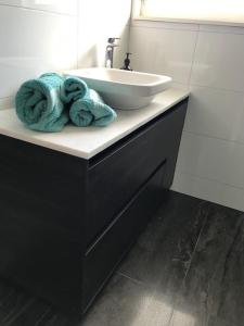 a bathroom with a sink and a counter with towels at TAURANGA, Bay of Plenty in Tauranga