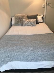 a bed with pillows on it in a room at TAURANGA, Bay of Plenty in Tauranga