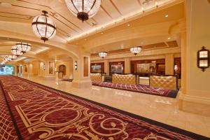 a large lobby with a large rug and chandeliers at River City Casino and Hotel in Lemay