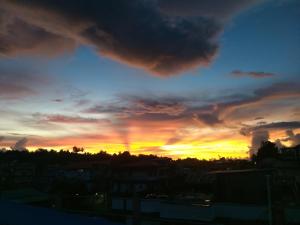 a sunset with a rainbow in the sky at Malakar Home stay in Port Blair +2 photos