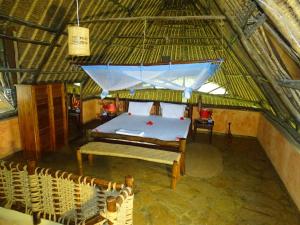 an attic room with a bed and a tent at Diani-Paradise-Villas in Diani Beach