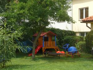 a playground with a tree and a swing at Penzion Dana Troja in Prague