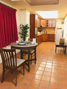 a kitchen with a table and chairs in a room at Nirvana Boutique Suites in Jomtien Beach