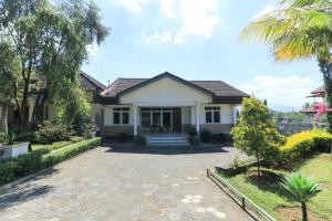 een huis met een oprit ervoor bij Villa Bunga in Malang