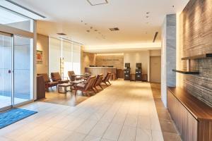 an office lobby with chairs and a table at &and COMFY HOTEL Kumamoto Jo View in Kumamoto