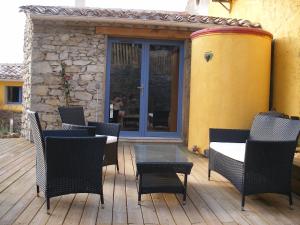 a patio with chairs and a table on a wooden deck at Domaine Les Cascades in Ribaute +41 photos