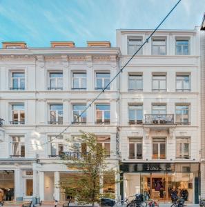 a large white building on a city street at The Bright Stone Lodge. Heart of Antwerp in Antwerp