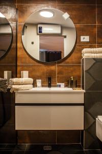 a bathroom with a sink and a mirror at Apartments Nora in Makarska