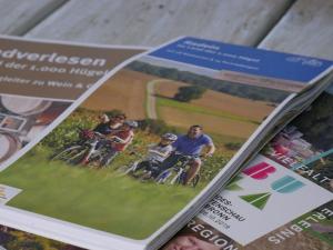 un magazine avec une photo d'un groupe de personnes faisant du vélo dans l'établissement Ferienhaus Knodel, à Sachsenheim