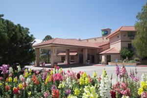 a red brick building with a flower garden at Holiday Inn Express Mesa Verde-Cortez, an IHG Hotel in Cortez