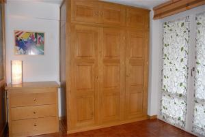 a room with a wooden closet and a dresser at Oasi Budden 1 in Breuil-Cervinia
