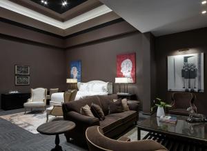a living room with a couch and a bed at Pelagos Suites Hotel & Spa in Kos